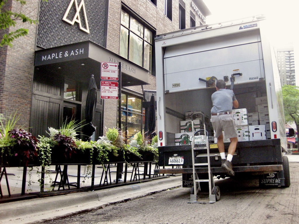 truck with boxes outside of a restaurant